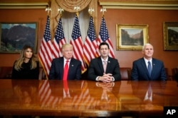 President-elect Donald Trump, his wife Melania and Vice president-elect Mike Pence, talk as they pose for photographers with House Speaker Paul Ryan of Wis. after a meeting in the Speaker's office on Capitol Hill in Washington, Nov. 10, 2016.