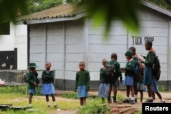 Pupils stand outside classrooms at a government school in the capital city of Harare, Zimbabwe, Feb. 5, 2019.