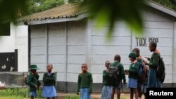 Pupils stand outside classrooms at a government school in the capital city of Harare, Zimbabwe February 5, 2019.