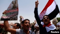 FILE - People shout slogans in support of the Yemen army and security forces in a U.S.-backed campaign against militant network al-Qaida in the Arabian Peninsula (AQAP), in Sana'a, May 21, 2014.