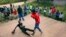 FILE - In this Feb. 12, 2017 photo, a young boy is knocked out during a boxing match in Chitungwiza, Zimbabwe.