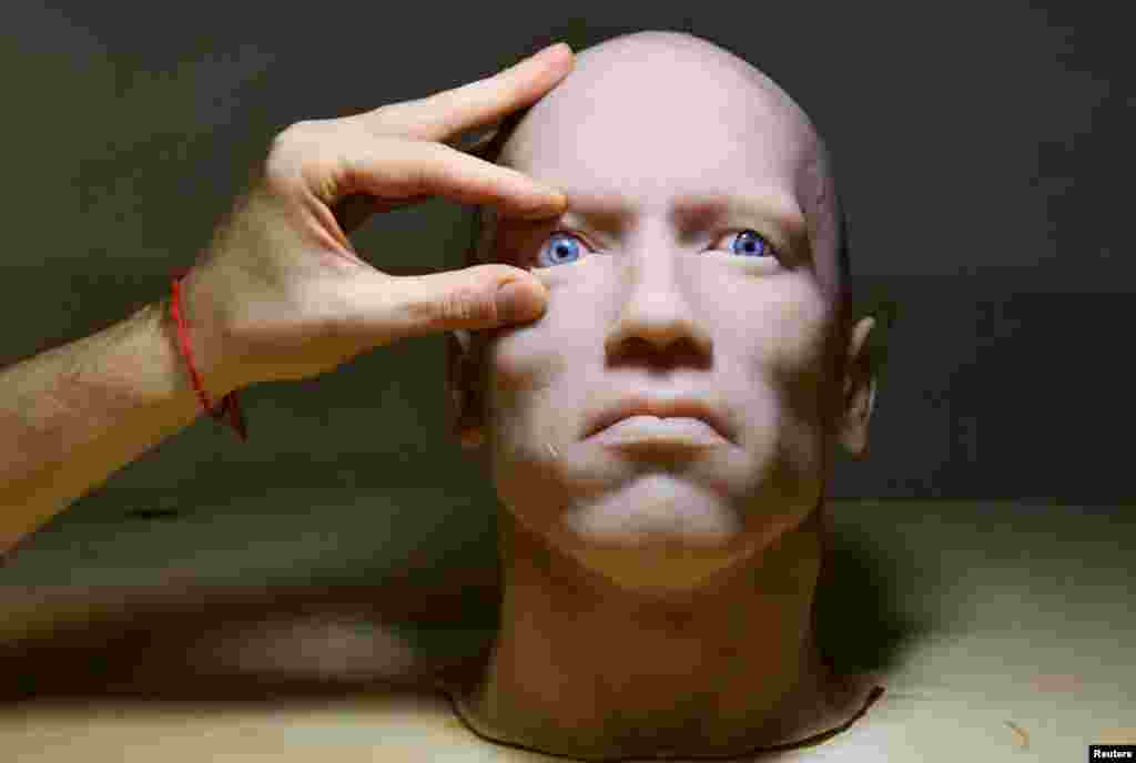 An employee works on a head of a humanoid robot developed by Promobot service robotics manufacturer at the company's branch in the far eastern city of Vladivostok, Russia.