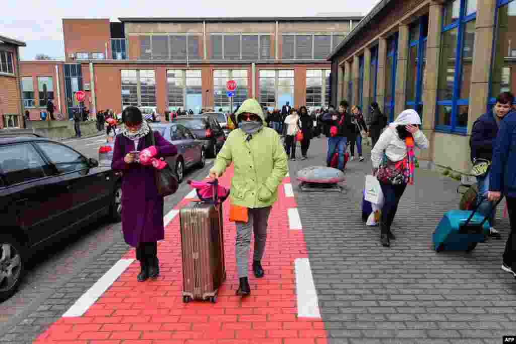 Passengers evacuating the Brussels Airport of Zaventem, after a string of explosions rocked Brussels airport and a city metro station, killing at least 21 people, as Belgium raised its terror threat to the maximum level, March 22, 2016