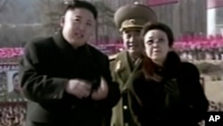In this Feb. 16, 2013 image made from video, North Korean leader Kim Jong Un, left, along with his aunt Kim Kyong Hui, right, attends a statue unveiling ceremony in Pyongyang.