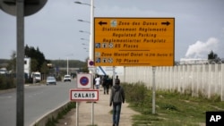 France Migrants Smuggling: FILE - In this Monday, Sept. 26, 2016 file photo, a migrant walks outside the makeshift camp in Calais, northern France. French authorities have arrested and convicted a top smuggler and his accomplice who had reigned over desperate migrants trying to sneak to Britain. 