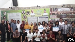 Alissa wahid (kerudung kuning) bersama Jaringan Gusdurian dan aktivis lintas agama dan keluarga korban bom gereja di Surabaya yang menerima donasi tanda kasih dari masyarakat di seluruh Indonesia, 23 Juli 2018.(Foto: Petrus Riski/VOA)