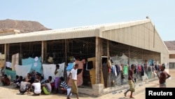 FILE - African migrants are pictured at a deportation center in Aden, Yemen, March 17, 2018.