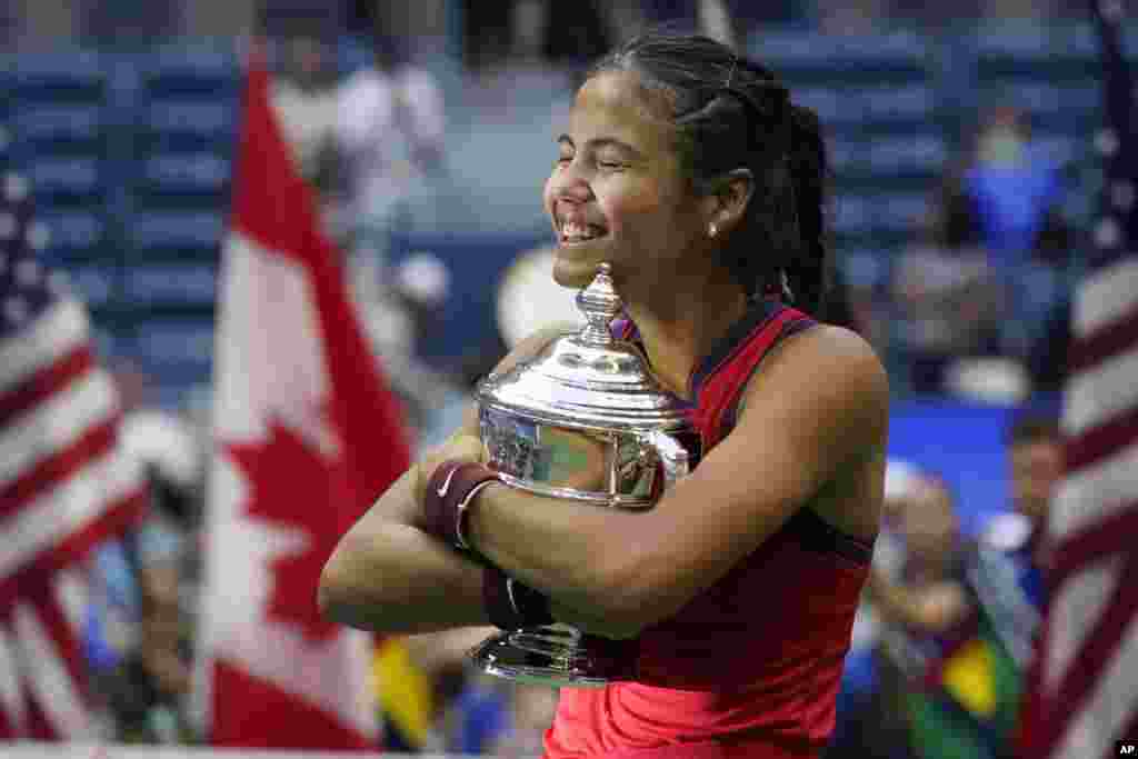 Emma Raducanu of Britain hugs the U.S. Open championship trophy after defeating Leylah Fernandez of Canada during the women&#39;s singles final of the U.S. Open tennis championships, Sept. 11, 2021, in New York.