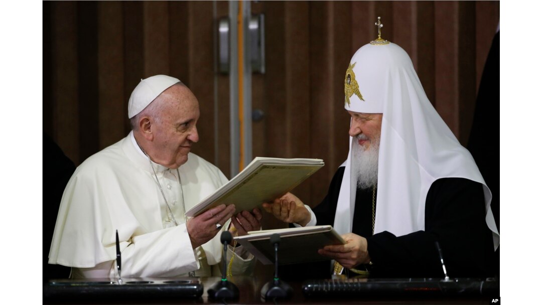 Pope Francis, left, and Russian Orthodox Patriarch Kirill exchange a joint declaration on religious unity at the Jose Marti International airport in Havana, Cuba, Feb. 12, 2016.