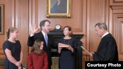 Chief Justice John Roberts administers the constitutional oath to Brett Kavanaugh at the Supreme Court building in Washington, Oct. 6, 2018, with the new justice's wife, Ashley, holding the Bible and their daughers looking on. (F. Schilling/Collection of 