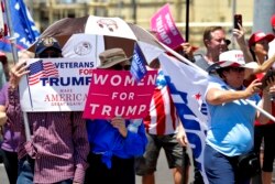 Supporters of President Donald Trump watch Air Force One land at Sky Harbor International Airport outside the Honeywell factory Tuesday, May 5, 2020, in Phoenix. Trump was visiting the manufacturer who has retooled to make N95 face masks in Phoenix