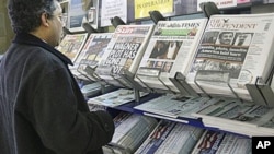 A man views a news stand displaying newspapers, some carrying the story on WikiLeaks' release of classified US State Department documents, in London, Nov. 29, 2010