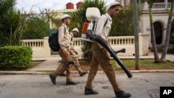 FILE - Government fumigators prepare to spray homes for mosquitoes in Havana, Cuba, Feb. 22, 2016.