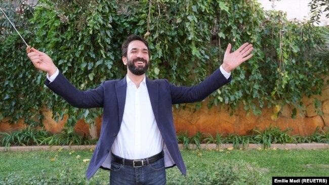 Conductor Lubnan Baalbaki stands for photo in Beirut, Lebanon on November 4, 2021. The reduced pay musicians receive has forced Baalbaki to reduce the number of shows from around 30 a year to just a few. (REUTERS/Emilie Madi)