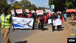FILE - Protesters march against attacks on people with albinism in Lilongwe, the capital of Malawi, in early 2016.