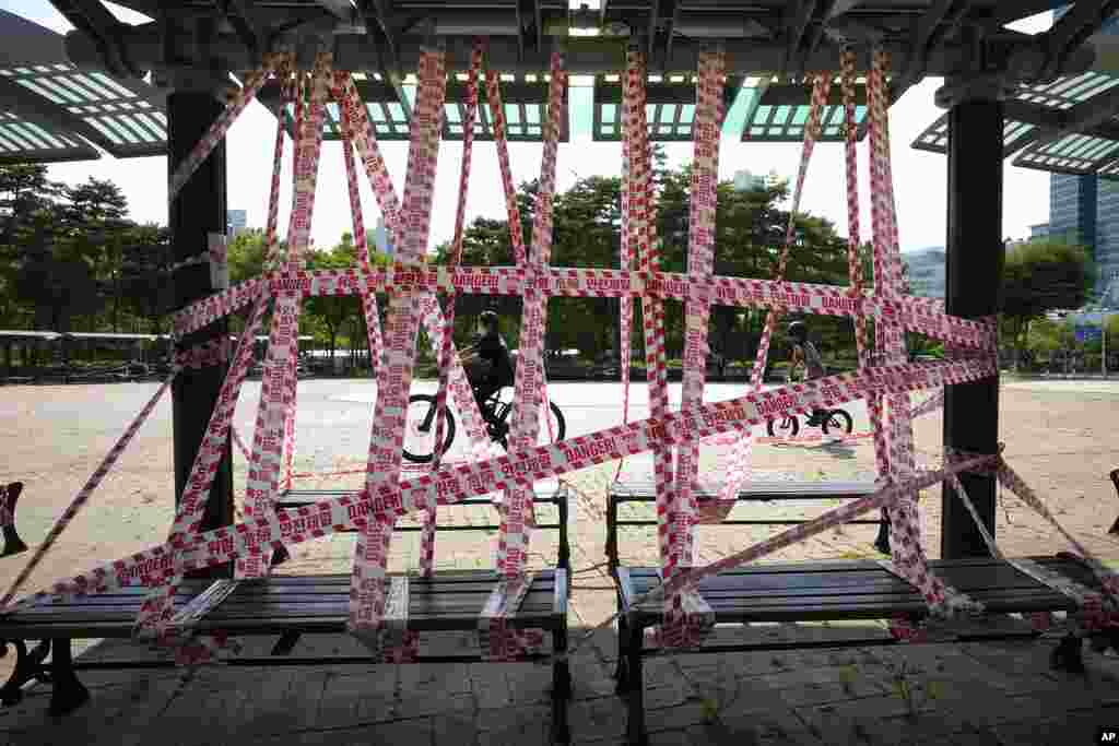 Public benches are taped off according to social distancing rules at a park in Anyang, South Korea.