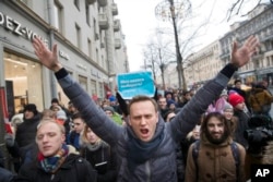 Russian opposition leader Alexei Navalny, centre, attends a rally in Moscow, Russia, Sunday, Jan. 28, 2018. Navalny was arrested Sunday in Moscow while walking with protesters, as protests take place across the country. (AP Photo/Evgeny Feldman)