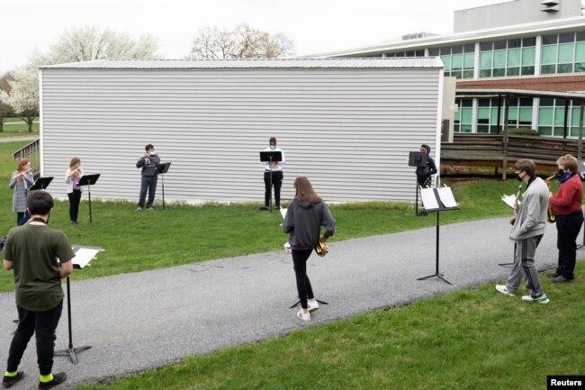 Students play instruments during a socially distanced band practice at Orefield Middle School in Orefield, Pennsylvania, April 12, 2021.