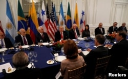 U.S. President Donald Trump, center, attends a working dinner with Latin American leaders in New York, Sept. 18, 2017.