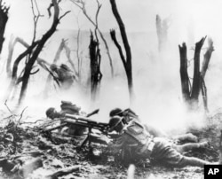 FILE - A U.S. Army 37-mm gun crew man their position during the World War I Meuse-Argonne Allied offensive in France, Sept. 26, 1918.