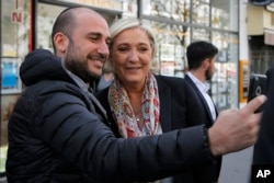 French far-right leader and candidate for the 2017 presidential election Marine Le Pen poses for a selfie after getting a haircut in Paris, April 24, 2017.