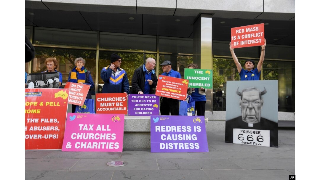 Protesters gather outside the County Court during the sentencing of Cardinal George Pell in Melbourne, Australia, Wednesday, March.13, 2019.