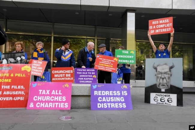 Protesters gather outside the County Court during the sentencing of Cardinal George Pell in Melbourne, Australia, Wednesday, March.13, 2019.