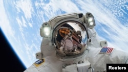 Astronaut Mike Hopkins, Expedition 38 Flight Engineer, is shown in this handout photo provided by NASA as he participates in the second of two spacewalks which took place on December 24, 2013, released on December 27, 2013. 