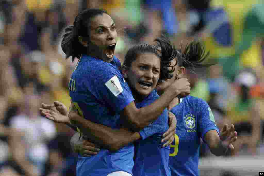 Brazil&#39;s Marta, left, celebrates with teammates after scoring the opening goal during the Women&#39;s World Cup Group C soccer match between Australia and Brazil at Stade de la Mosson in Montpellier, France.