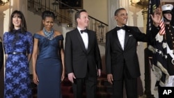 President Barack Obama and first lady Michelle Obama pose for an official photo with British Prime Minister David Cameron and his wife, Samantha Cameron, before the White House state dinner, March 14, 2012.