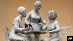 This Oct. 6, 2019 photo provided by Michael Bergmann shows a one-third scale clay model of Sojourner Truth, left, Susan B. Anthony, center, and Elizabeth Cady Stanton at Meredith Bergmann's studio in Ridgefield, Connecticut.(Michael Bergmann via AP)