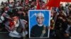 FILE - An image of deposed Myanmar President Win Myint is displayed at an anti-coup rally in Yangon, Myanmar, Feb. 20, 2021. 