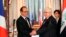 French President Francois Hollande shakes hands with Iraqi President Fuad Masum, right, during a news conference in Baghdad, Sept. 12, 2014. 