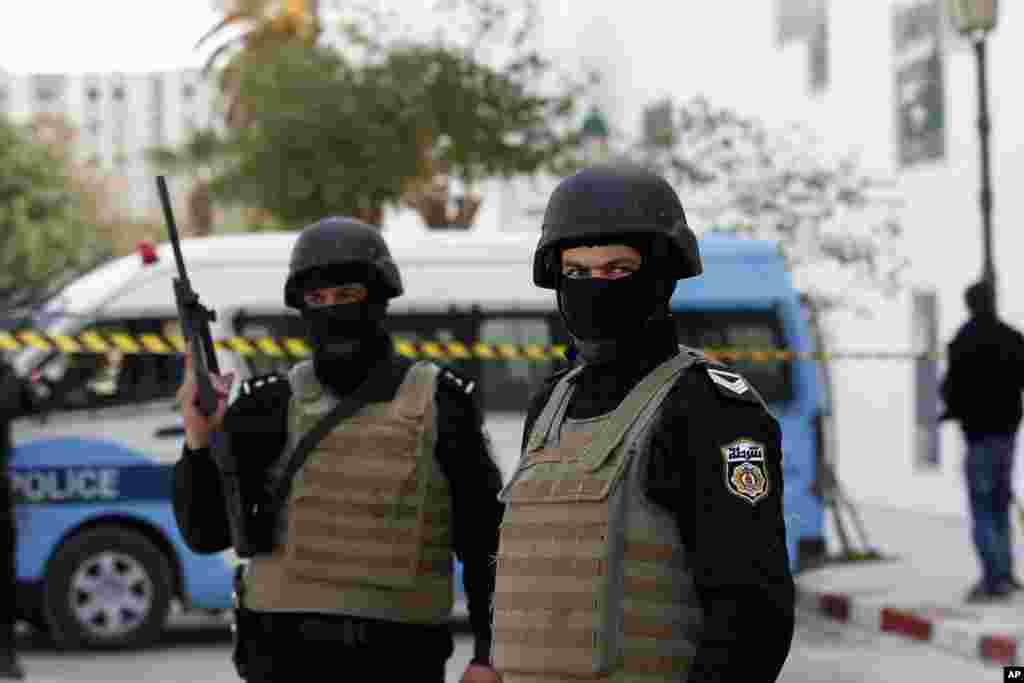 Police officers guard the entrance of the National Bardo Museum a day after gunmen opened fire killing scores of people in Tunis, March 19, 2015.