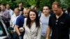 Sviatlana Tsikhanouskaya, candidate for the presidential elections, center, surrounded by her supporters walks after voting at a polling station in Minsk, Belarus, Aug. 9, 2020.
