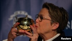 Actor Annette Bening kisses her Pudding Pot Award after a ceremony to honor her as Hasty Pudding Theatricals' Woman of the Year at Harvard University in Cambridge, Massachusetts, Feb. 6, 2024. 