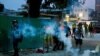 Demonstrators are caught in tear gas during a protest against the Yuen Long attacks in Yuen Long, New Territories, Hong Kong, July 27, 2019.