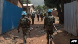 FILE - oldiers from the United Nations Multidimensional Integrated Stabilization Mission in the Central African Republic (MINUSCA) patrol in PK12, 12 kilometers from downtown Bangui, where fighting raged, Jan. 13, 2021.