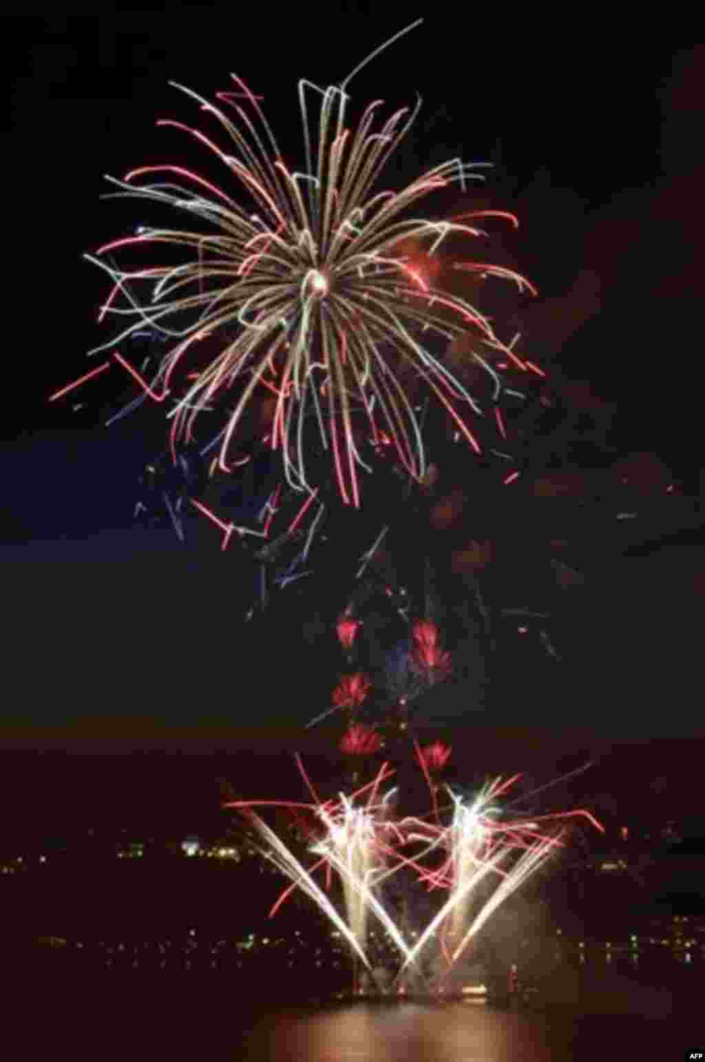 Fireworks are launched from barges in the Hudson River in New York, Monday, July 4, 2011. (AP Photo/Seth Wenig)