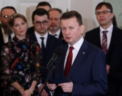 FILE - Polish Defense Minister Mariusz Blaszczak attends a government swearing-in ceremony at the Presidential Palace in Warsaw, Poland, Jan. 9, 2018.