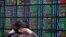 An investor monitors the stock market at a securities brokerage in Taipei, Apr. 16, 2013.