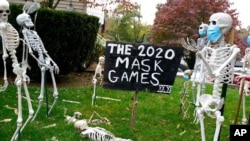 Coronavirus-themed Halloween decorations are displayed on a lawn in Tenafly, N.J., Oct. 22, 2020. 