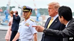 U.S. President Donald Trump, with Japan's Prime Minister Shinzo Abe, is seen as he leaves the Japanese destroyer JS Kaga, after a tour in Yokosuka, south of Tokyo, Japan, May 28, 2019.