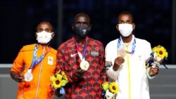 FILE - Marathon gold medalist Eliud Kipchoge of Kenya, center, stands with silver medalist Abdi Nageeye of Netherlands, left, and bronze medalist Bashir Abdi of Belgium during the closing ceremony at the 2020 Olympics in Tokyo, Aug. 8, 2021.