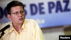 Revolutionary Armed Forces of Colombia (FARC) negotiator Pablo Catatumbo reads a document after arriving for talks in Havana, Cuba, Jan. 15, 2014. 
