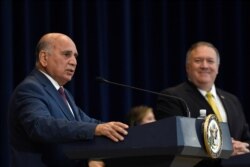 FILE - Iraqi Foreign Minister Fuad Hussein, left, speaks during a news conference with Secretary of State Mike Pompeo at the State Department in Washington, Aug. 19, 2020.