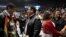 FILE - Same-sex couples Juan Jose Murillo, far left, and Ernesto Alonso Osuna, and Lorena Ramirez, right, with Rosa Isaura Vega take part in a mass wedding ceremony at the Municipal Auditorium in Tijuana, Baja California, Mexico, on Feb. 14, 2020. 