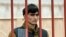 In this photo released by the Basmanny District Court press service on April 27, 2024, Dzhumokhon Kurbonov, a suspect in the Crocus City Hall shooting, stands in a cage in court in Moscow, Russia.