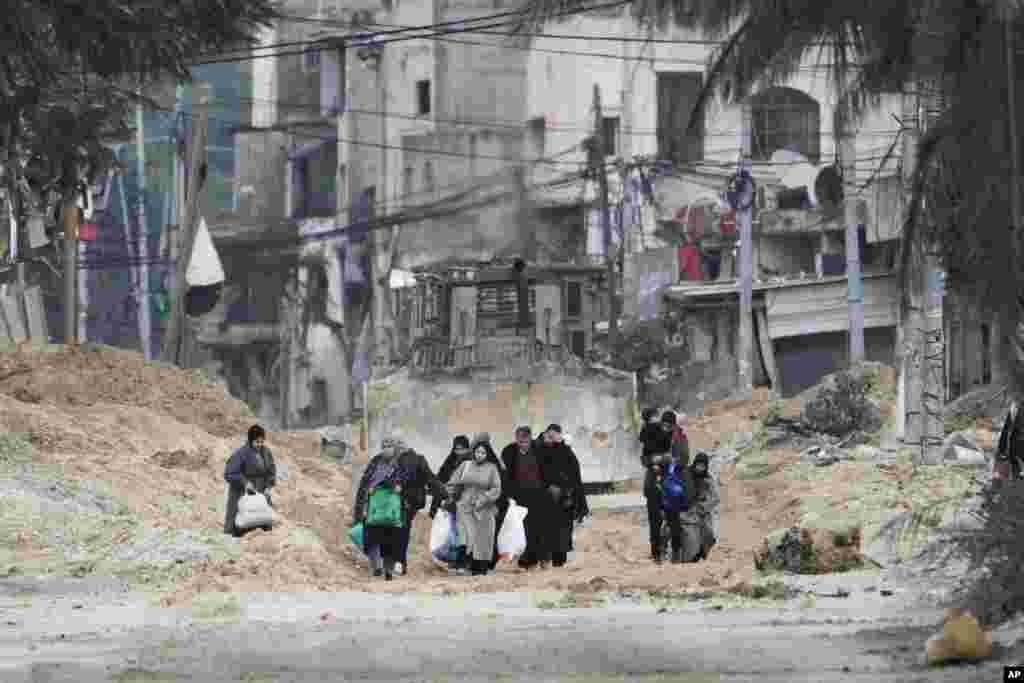 Residents of the West Bank refugee camp of Nur Shams, Tulkarem, evacuate their homes as the Israeli military continues its operation in the area.