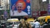 A soldier stands guard near a billboard showing Pope Francis, a day ahead of his arrival in Kinshasa, Democratic Republic of Congo Jan. 30, 2023.